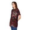 A woman wearing a black t-shirt with a repeating pattern of red dragon scales.