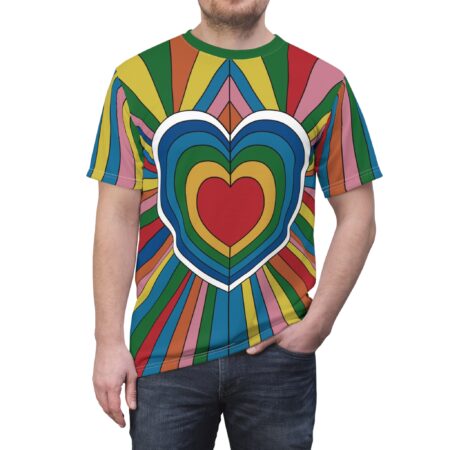Rainbow stripes and concentric heart shapes in red, yellow, blue, and green cover this patterned tee shirt, radiating outwards from a central red heart.