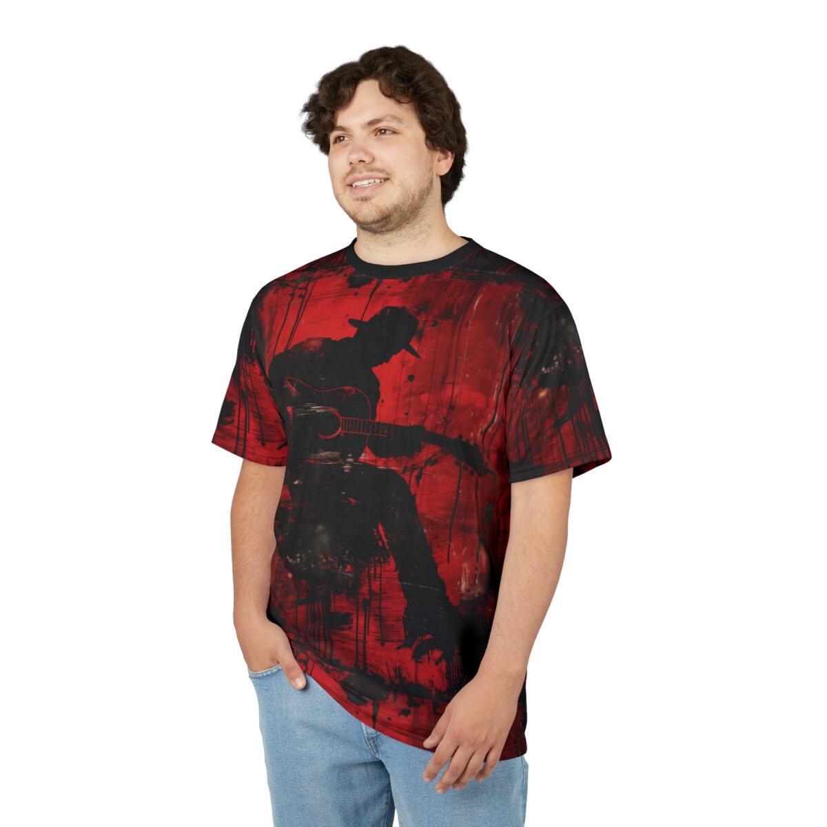 Red and black abstract paint strokes cover this patterned tee shirt, featuring a silhouette of a musician playing guitar.