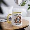 White ceramic mug with yellow handle and rim, featuring a cartoon sloth holding a polka-dot mug and the text "BUSY DOING NOTHING".