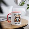 White ceramic mug with a bright red handle and rim, featuring a cartoon sloth holding a polka-dot cup.