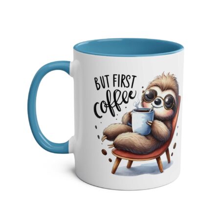 White ceramic mug with a blue handle and interior, featuring a cartoon sloth in sunglasses holding a coffee cup.