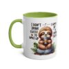 White ceramic mug with a green handle and interior, featuring a cute sloth illustration and text about coffee.