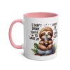 White ceramic mug with a pink interior and handle, featuring a cute sloth drinking coffee.