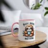 White mug with pink handle and rim, featuring a cute sloth holding a polka dot mug and the text "BUSY DOING NOTHING".