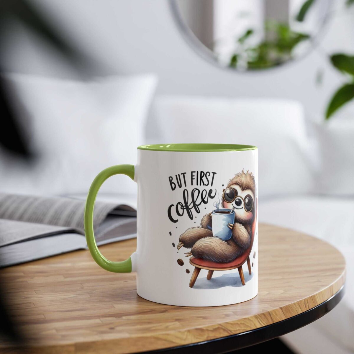 A white mug with a green rim and handle, featuring a cartoon sloth holding coffee.