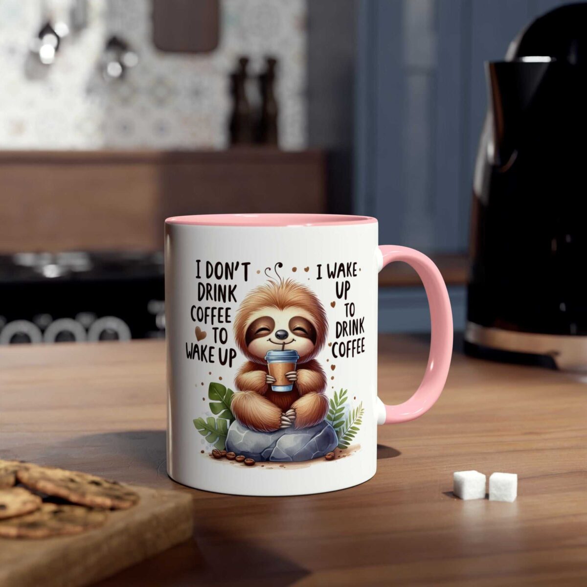 White ceramic mug with a cute sloth illustration holding a coffee cup and a pink handle.