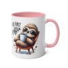White mug with a pink handle and inner rim. Features a cute, fuzzy sloth wearing sunglasses, holding a coffee cup.