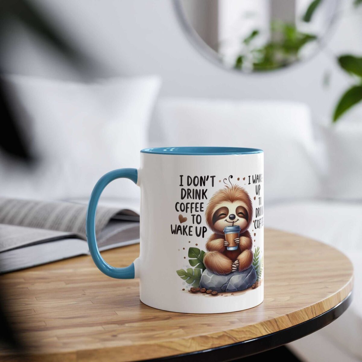 White ceramic mug with a blue interior and handle, featuring a cartoon sloth holding a coffee cup.