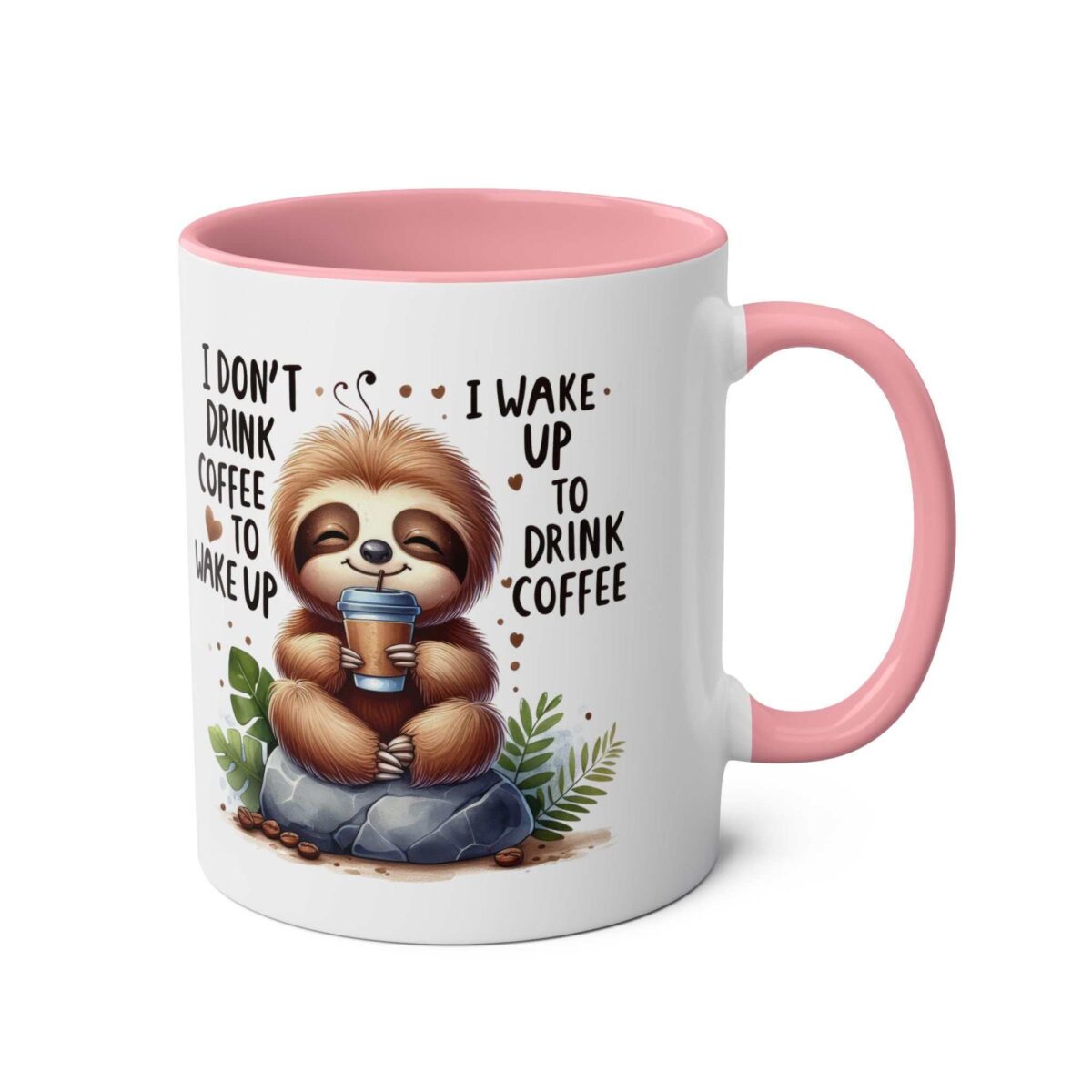 White ceramic mug with a pink handle and interior, featuring a cute sloth holding a coffee cup and text.