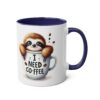 White mug with a cute sloth peeking out of a coffee cup, dark blue handle and interior.
