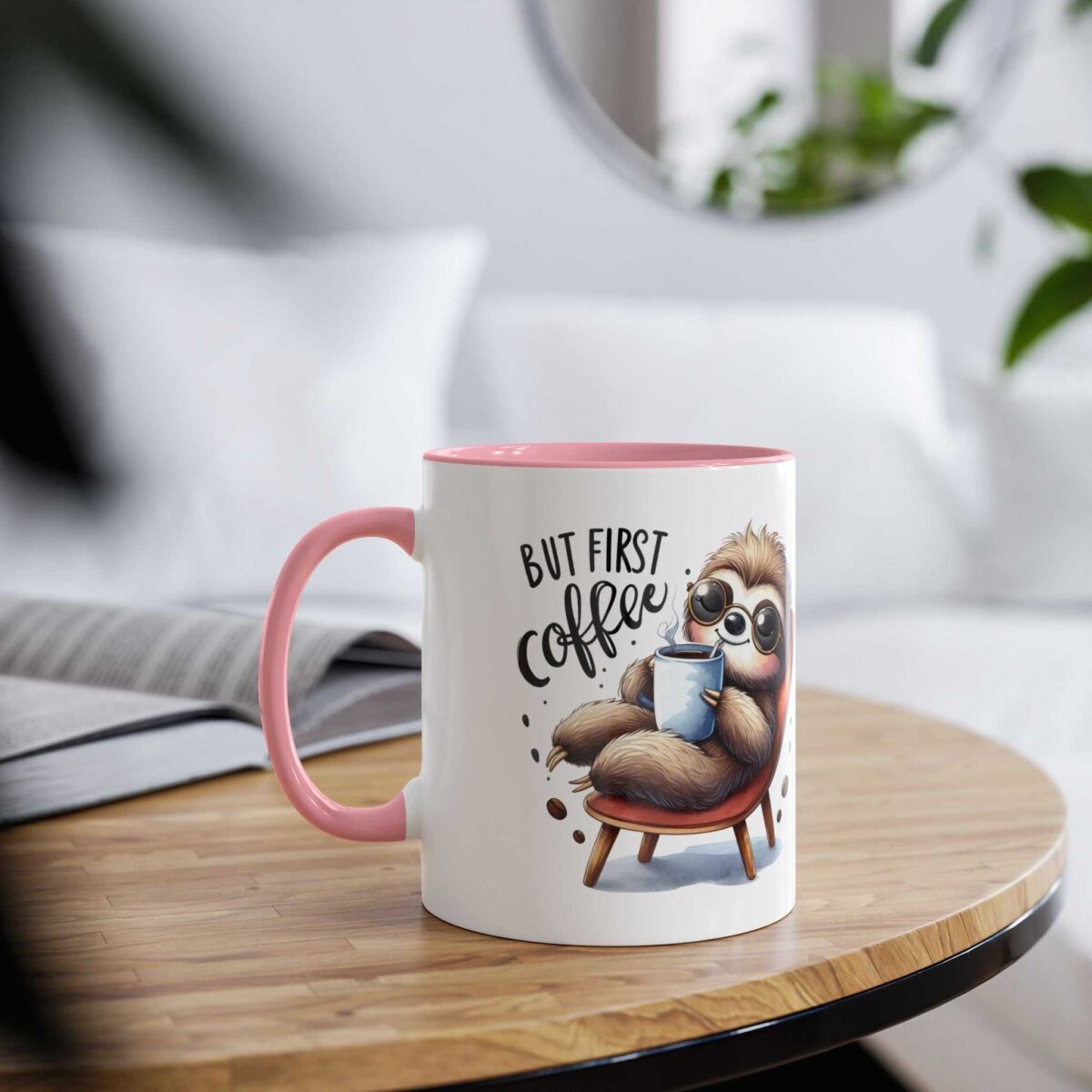 A white mug with a pink handle and rim, featuring a cartoon sloth in sunglasses holding a coffee cup.