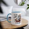 White ceramic mug with a blue interior and handle, featuring a cartoon sloth holding coffee.