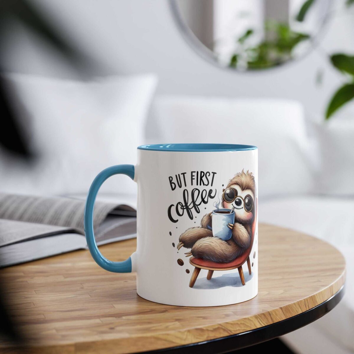 White ceramic mug with a blue interior and handle, featuring a cartoon sloth holding coffee.