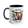 White ceramic mug with black handle and rim, featuring a whimsical sloth hanging from a branch with leaves and text "FUN FACT + I DON'T CARE."