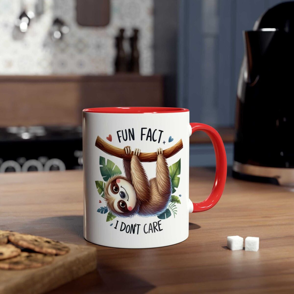 White ceramic mug with a red handle and rim, featuring a cartoon sloth hanging from a branch with leaves.