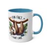 White ceramic mug with blue handle and interior, featuring a furry sloth hanging from a branch with leaves. Text reads "FUN FACT... I DON'T CARE".