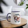 A white ceramic mug with a navy blue rim and handle, featuring a cartoon sloth in a hammock with the words "NOPE NOT TODAY".