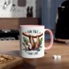 A white ceramic coffee mug with a pink rim and handle, featuring a sloth illustration.