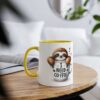 White ceramic mug with a yellow handle and rim, featuring a cartoon sloth peeking out of a coffee cup that says "I NEED COFFEE."
