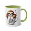 A white ceramic mug with a green interior and handle, featuring a cartoon sloth peeking out of a coffee cup that says "I Need Coffee".