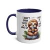 White ceramic mug with a blue interior and handle, featuring a cute sloth illustration and coffee-themed text.