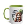 Cute sloth graphic mug with "Sorry I Can't I'm Very Busy" text, featuring a green interior and handle.