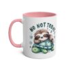 White ceramic mug with pink handle and interior, featuring a sleeping sloth on a turtle.