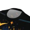 Yellow and orange starbursts, blue and yellow stars, and light blue and orange streaks cover this patterned tee shirt, depicting a cosmic night sky with a comet.