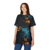 A woman wearing a black t-shirt with a dark, eerie Halloween-themed graphic featuring carved pumpkins with glowing eyes, set against a backdrop of a foggy forest and bare trees.