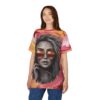Swirling pink, yellow, and orange abstract patterns surround a grayscale portrait of a woman with sunglasses on this tee shirt.