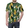 Lush green and golden banana leaves with white veins cover this graphic t-shirt, with hints of pale pink in the background.