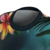 Tropical floral all over print sublimation tee, featuring vibrant plumeria flowers and dark green palm leaves on a teal background.