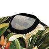 Vibrant orange and creamy yellow tropical flowers and lush green leaves cover this 3D graphic t-shirt, set against a black background.