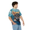 A person wearing a blue t-shirt featuring a cute fluffy puppy in scuba gear underwater with coral and fish.