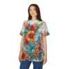 Vibrant oranges, reds, and blues in a lush floral arrangement with green leaves cover this seamless pattern tee, depicting a painterly botanical scene.