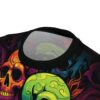 Close-up of a t-shirt with a vibrant, neon-colored skull graphic and abstract swirling patterns on black fabric, showing the collar.