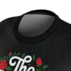 Black t-shirt with white text and red roses floral graphic design, vintage aesthetic.