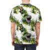 Green and white watercolor T-Rexes with leafy accents cover this patterned tee shirt with a prehistoric vibe.