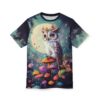 A magical t-shirt design featuring a white owl with bright orange eyes and a flower crown, sitting on a vibrant orange mushroom. The owl is surrounded by a colorful array of smaller mushrooms, pink and yellow flowers, and glowing fireflies against a dark, starry night sky with a large full moon.