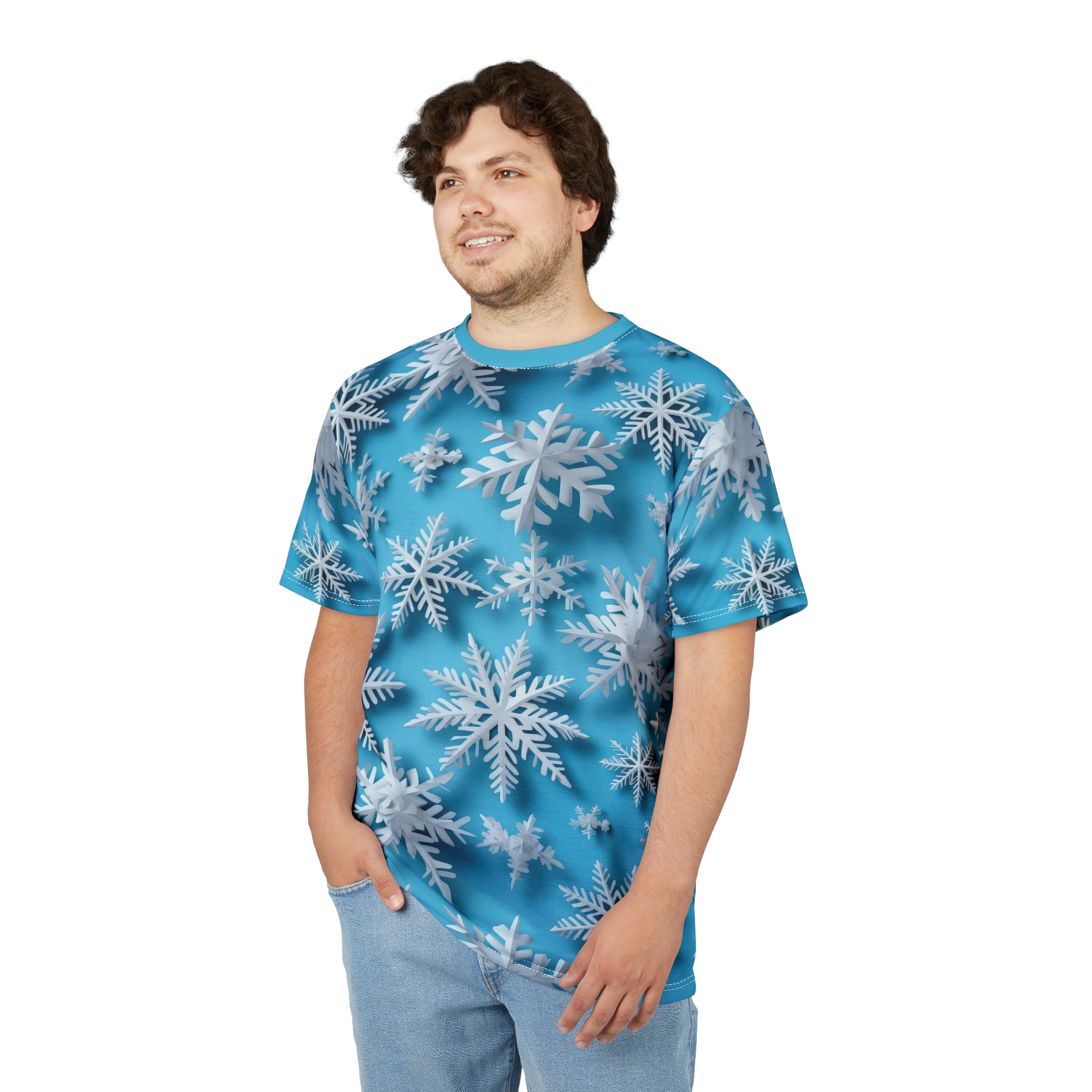 White and silver 3D snowflakes cover this t-shirt, set against a bright blue background with subtle gradient effects.