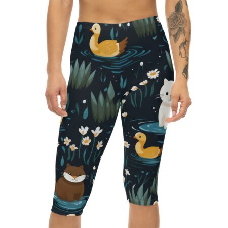Women's capri leggings featuring a dark blue pond pattern with cartoon ducks, otters, cats, and white flowers.