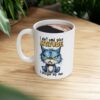White ceramic mug with a grumpy blue cat design and sassy text that reads