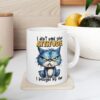 White ceramic mug with a grumpy blue cat illustration and bold text saying