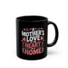This black mug features the heartwarming quote 'A Mother's Love Is The Heart Of A Home' in stylized white and pink lettering with small heart and star accents.