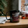 Black mug features white and pink text that reads 'A Mother's Love Is The Heart Of A Home,' accented with hearts and stars.