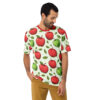 Red and green apples with scattered leaves cover this all over print apparel, on a light green background.