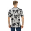 Black ink splatters and distressed skull graphics cover this seamless pattern tee, with drips and splashes on a light gray background.