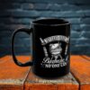 A black ceramic mug with a white graphic of a grill and text reading "If Dad Can't Barbecue It No One Can".