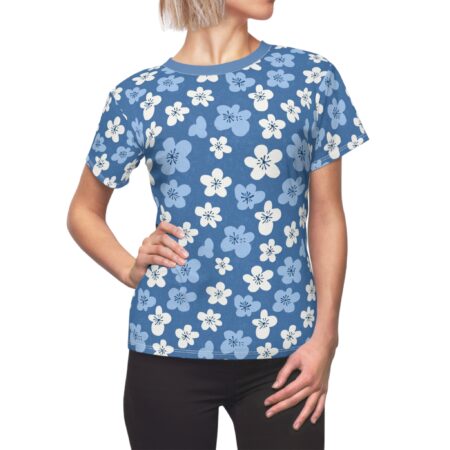 White and light blue cherry blossoms cover this seamless pattern tee, set against a medium blue background.